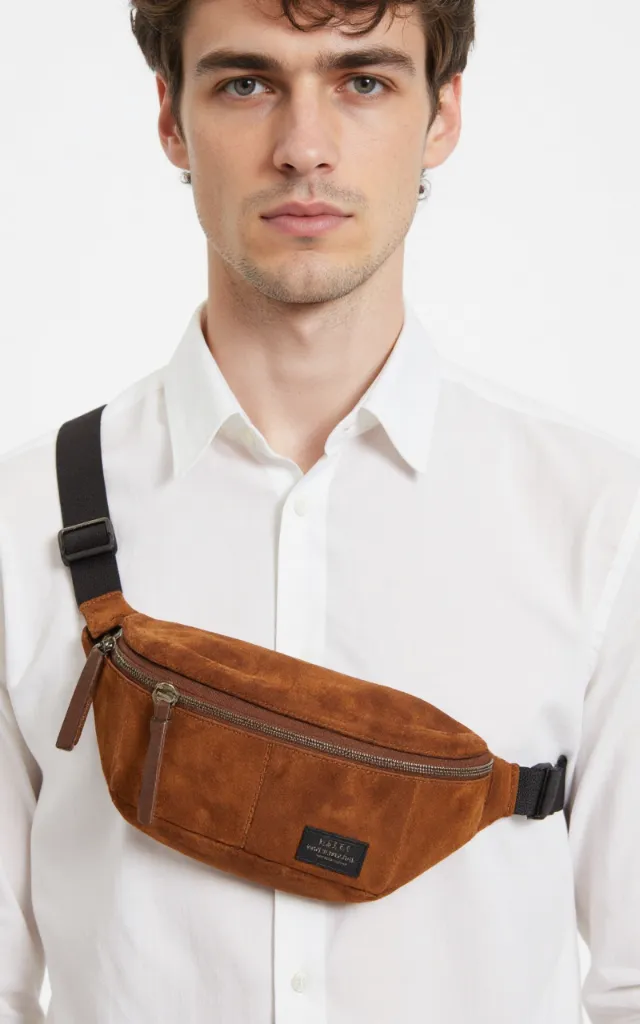 A French male model with a Suede   textured waist bag, wearing a shirt, against a white background, in a front   facing close   up